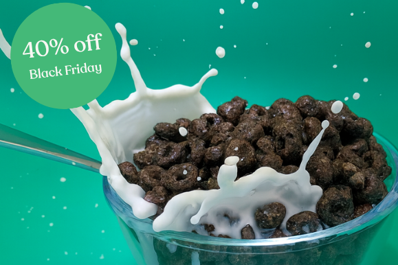 Chocolate cereal with milk splashes in a bowl on a green background with Black Friday promotion text.
